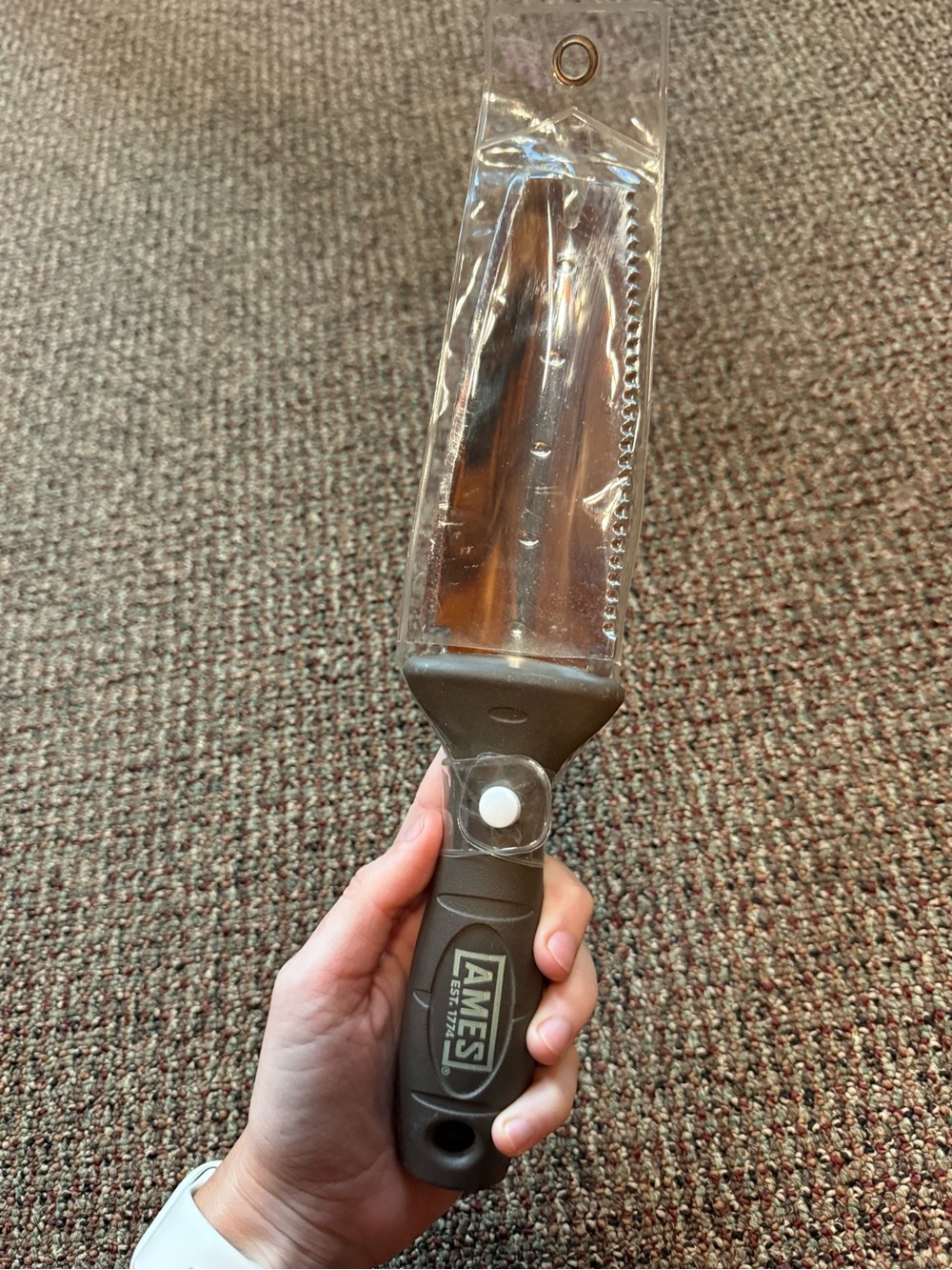 Gardening tool in plastic packaging